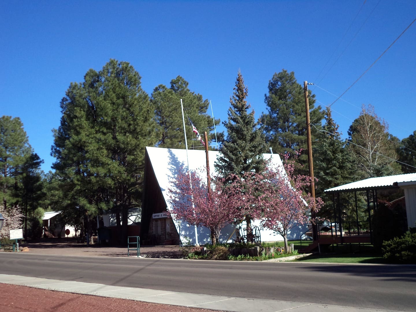 A white building with trees in the background