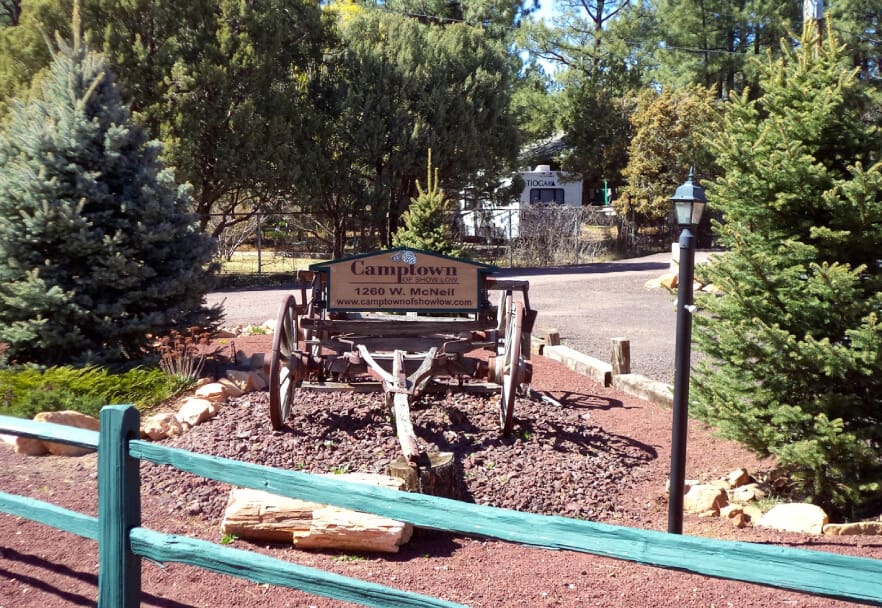 A wooden bench in the middle of a park.